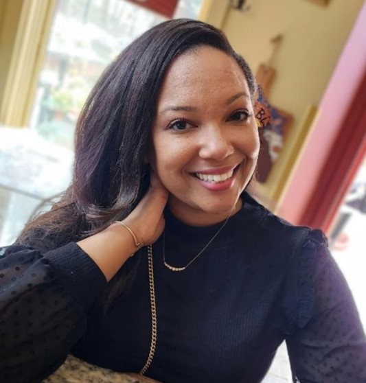 Nicole_James seen with a bright smile on her face and in a full black color outfit